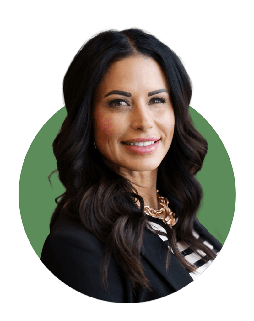 A woman with long dark hair, wearing a black blazer, striped top, and gold necklace, smiles at the camera against a green circular background, representing a trusted Arizona commercial contractor.