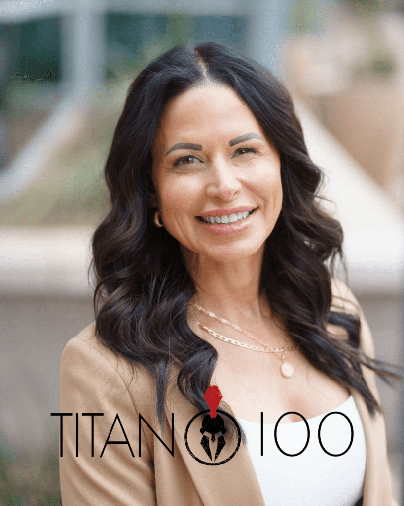 A woman with long dark hair, wearing a tan blazer and white top, smiles at the camera. The text "TITAN 100" with a Spartan helmet logo is overlaid, highlighting why clean job sites save lives—and money.