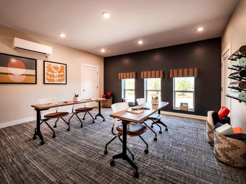 Multi purpose room for Monte Nido Rosewood - Eating Disorder Recovery Center. This room includes a desks and chairs with carpet and large windows.