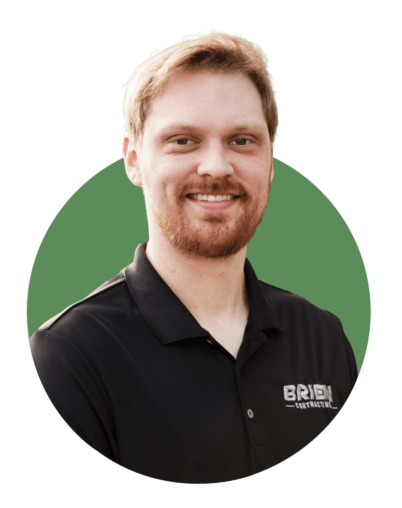 Headshot photo of Project Manager Adam with Brien Contracting. He is wearing a black polo shirt and has facial hair.