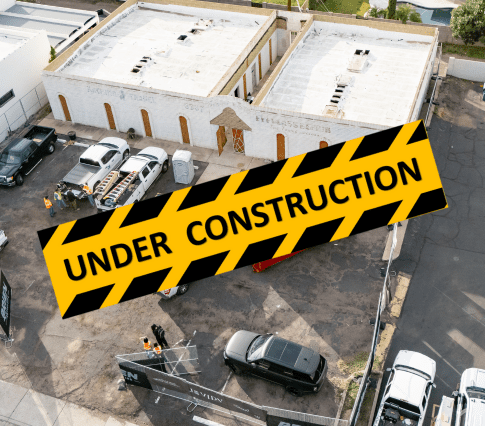 Drone photo of Jevidy wellness, hospitality and medical build in Phoenix, Arizona. Two white medical buildings for adaptive reuse commercial construction of wellness center.